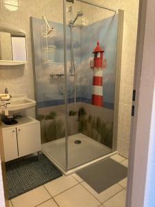 a bathroom with a shower with a lighthouse on the wall at Ferienwohnung am Waldrand in Traben-Trarbach