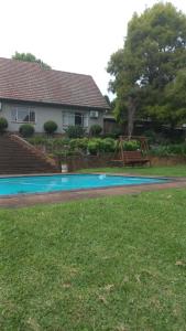 a house with a swimming pool in the yard at Me, myself, I Glamping in Pietermaritzburg