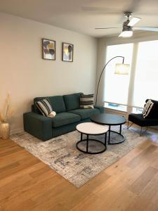 a living room with a green couch and a table at Luxe Mid-Downtown apartment in Houston