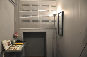a living room with a fireplace and a window at GRAYHAUS Guest House in Petaling Jaya