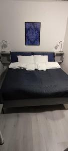 a bed with two pillows on it in a room at Villa Pikkumustikka in Töysä