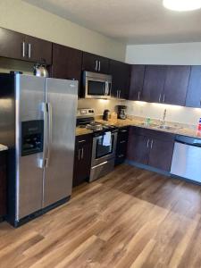 a kitchen with stainless steel appliances and wooden floors at River View in Pittsburgh