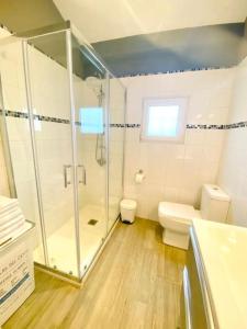 a bathroom with a shower and a toilet at Casa a la orilla del mar in Neda