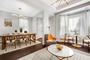 a dining room and living room with a table and chairs at The Logandale: HUGE Mid-Century Home, sleeps 15 in Chicago