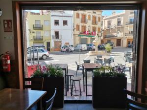 a view from a window of a street with tables and chairs at Apartamento Rural La Plaza Vieja in Viver