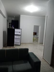 a living room with a couch and a kitchen at Ikea flat 6 in Hurghada