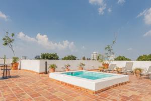 a pool on a brick patio with chairs and a table at Casa Monarcas - Sophia (with AC) in Guadalajara