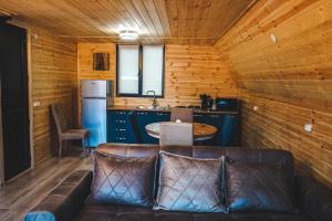 a living room with a couch and a kitchen at Morning Star Kazbegi in Kazbegi