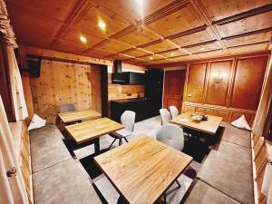 a dining room with wooden tables and chairs at Apart Harmonie in Kappl