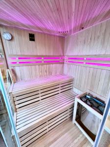 a small cabin with pink lights on the ceiling at Love Apartment Riga in Rīga