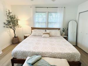 a bedroom with a large bed and a window at Coastal Cottage By Vilano in St. Augustine