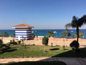 a building on the beach with the ocean in the background at Hotel apartments - porto el sokhna - family only in Ain Sokhna