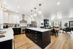 a kitchen with white cabinets and a dining room at The Sister Bay Haus in Sister Bay