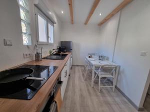 a kitchen with a counter and a table in it at Le Rawai in Fos-sur-Mer +2 photos