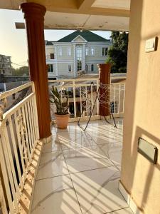 a balcony with a view of a house at Luxury 2 bedroom flat KerrSerign in Banjul