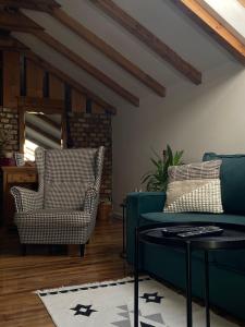 a living room with a blue couch and a chair at Apartman Park in Zlatibor