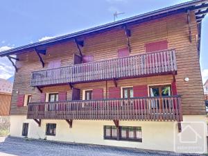 a large wooden building with a balcony on it at Résidence La Ruche-Appartement ISOARD (T2) in Les Carroz d'Araches