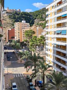 an aerial view of a city with palm trees and buildings at Cullera Confort Playa in Cullera