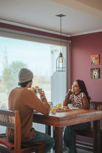 a man and a woman sitting at a table eating food at casArtero eco posada in San Rafael +33 photos