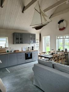 a kitchen with a couch and a table in it at Litet hus i mysig by nära havet in Ystad