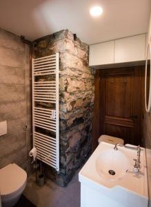 a bathroom with a sink and a stone wall at Kuća za odmor “Dobra” - Skrad, Gorski kotar in Skrad