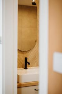 a bathroom with a sink and a mirror at Czorsztyn Glamp in Maniowy