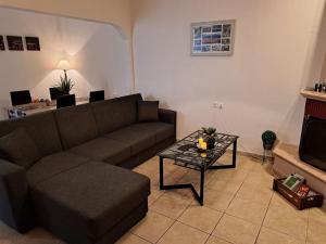 a living room with a couch and a coffee table at Home Pap in Volos