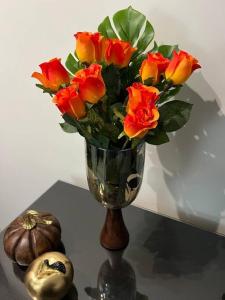 a vase filled with red and yellow roses on a table at Luxury Privé Penthouse in Serres
