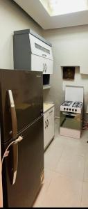 a kitchen with a black refrigerator and a stove at Formidable of Cairo in Cairo