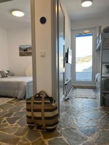 a suitcase sitting in a room with a bedroom at Sea views - Marble Palace - 2 floors in Tinos Town