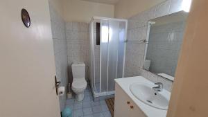 a bathroom with a toilet and a sink and a shower at Seaside 2BR Apartment 30m from Sea & Free Parking in Oroklini +33 photos