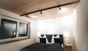 a bedroom with a bed and a window at Apartment Lola in Seefeld in Tirol