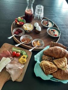 a table topped with different types of food on plates at Luxury Suites Oosterwold in Almere