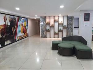 a living room with a couch and a table in a building at Imperial Tambau By Loui in João Pessoa