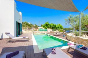 a villa with a swimming pool and a patio at Luxury Villa Murtal with private pool in Gerani