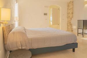Ein Bett oder Betten in einem Zimmer der Unterkunft La volpe e l'uva Dimore