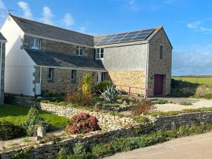 a house with solar panels on the roof at Beautiful Cornish Home "High on the Cliffs" in Praa Sands