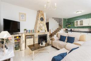 a living room with a couch and a fireplace at Villa Flower in Cómpeta