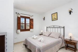 a bedroom with a bed with two towels on it at Villa Flower in Cómpeta +9 photos
