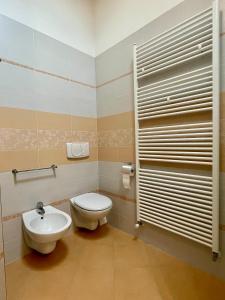 a bathroom with a toilet and a sink at Trilo Riflessi d'Alpe in Lavarone