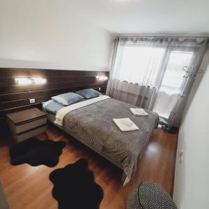 a bedroom with a bed and two cats laying on the floor at VIP Apartments Belvedere with terrace K105 in Bansko