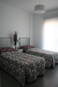 Postel nebo postele na pokoji v ubytování Apartment OasisBeach La Zenia
