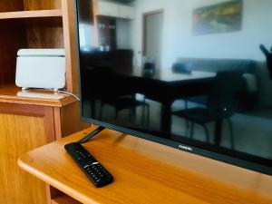 a computer monitor and a remote control sitting on a table at Cocò Marì in Naples