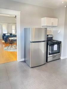 a kitchen with a stainless steel refrigerator and a stove at Perfect! near CLE Clinic/Case/UH/Downtown! in Cleveland