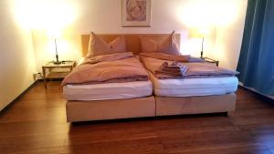 a bed with two pillows on it in a room at il fiore Hotel Steinach SG in Steinach