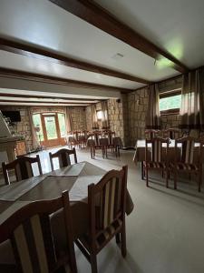 a dining room with wooden tables and chairs at Respect in Mykulychyn +117 photos