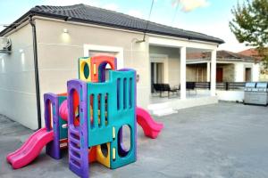 a playground in front of a house at Little village Trikala 