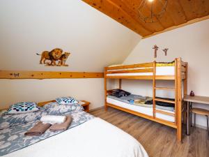 a bedroom with two bunk beds and a ladder at Gazdówka na Mosornym Groniu in Zawoja