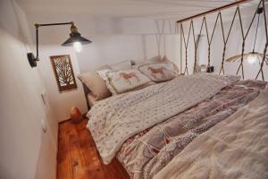 a bedroom with a bed with a wooden floor at Unique hunter's hut concept tiny house in Küçük Çığlı