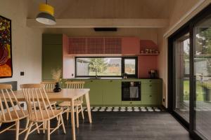 a kitchen with a table and chairs and a window at laba in Lasowka